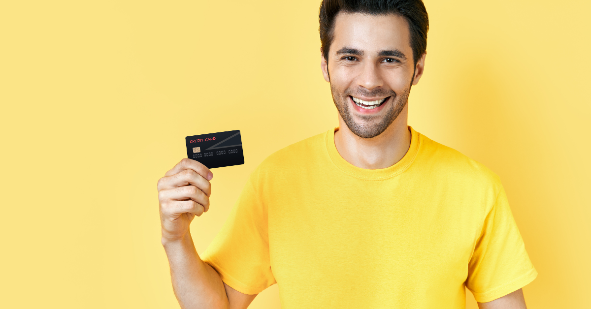 A traveller holding a credit card, booking a trip through Expedia Travelocity Expedia Orbitz